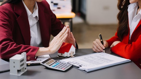 Discussion with a real estate agent house model with agent and customer discussing for the contract to buy get insurance or loan real estate or property free photo